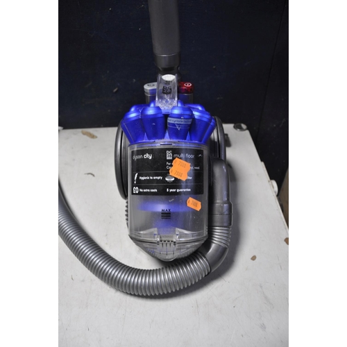 1054 - A DYSON DC24 MULTIFLOOR VACUUM along with a Bush VCS35B15KOD-70 vacuum cleaner and a Miele compact c... 