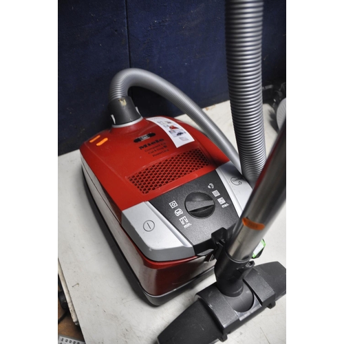 1054 - A DYSON DC24 MULTIFLOOR VACUUM along with a Bush VCS35B15KOD-70 vacuum cleaner and a Miele compact c... 