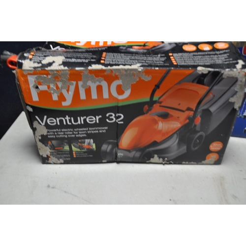 1077 - A FLYMO VENTURER32 LAWNMOWER in original box (UNTESTED) along with a JJB leg magic multi exercise ap... 