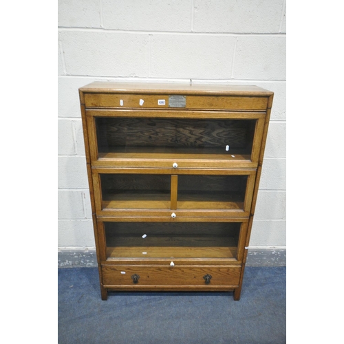 1202 - AN EARLY TO MID 20TH CENTURY OAK THREE SECTIONAL BOOKCASE, with three glazed hide and fall doors, ab... 