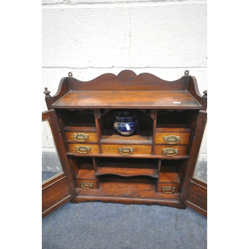 1211 - AN EARLY 20TH CENTURY OAK SMOKERS CABINET, with two bevelled glass doors, that enclosing a fitted in... 