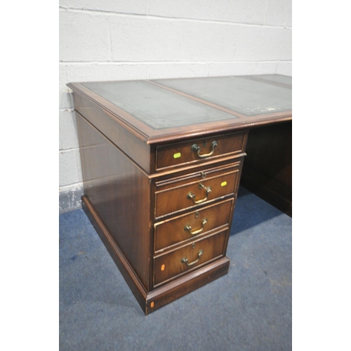 1218 - A REPRODUCTION MAHOGANY PEDESTAL DESK, teal leather writing surface, with an arrangement of six draw... 