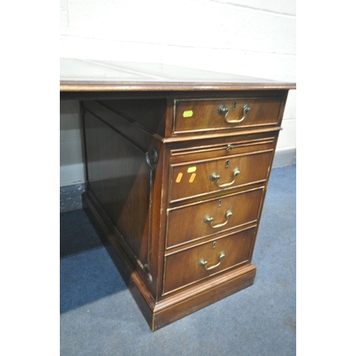 1218 - A REPRODUCTION MAHOGANY PEDESTAL DESK, teal leather writing surface, with an arrangement of six draw... 