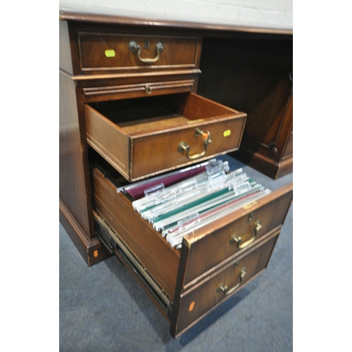 1218 - A REPRODUCTION MAHOGANY PEDESTAL DESK, teal leather writing surface, with an arrangement of six draw... 