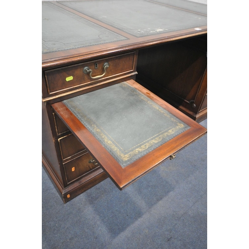 1218 - A REPRODUCTION MAHOGANY PEDESTAL DESK, teal leather writing surface, with an arrangement of six draw... 