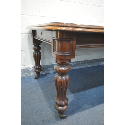 1219 - A VICTORIAN WALNUT WIND OUT DINING TABLE, with two leaves, on fluted legs, extended length 207cm x c... 