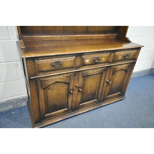 1258 - A REPRODUCTION OAK DRESSER, with three drawers, width 137cm x depth 49cm x depth 159cm x 85cm