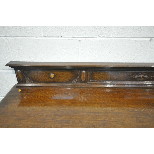 1277 - A 20TH CENTURY SOLID OAK SIDEBOARD, with a raised back, three drawers, left drawer with green baize ... 