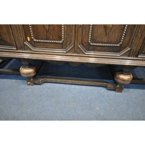 1277 - A 20TH CENTURY SOLID OAK SIDEBOARD, with a raised back, three drawers, left drawer with green baize ... 