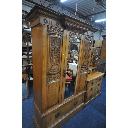 1279 - AN EARLY 20TH CENTURY CARVED OAK BEDROOM SUITE, comprising a single mirror door wardrobe, with a sin... 