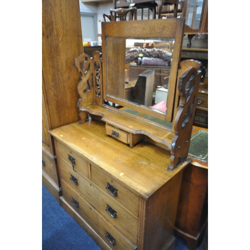 1279 - AN EARLY 20TH CENTURY CARVED OAK BEDROOM SUITE, comprising a single mirror door wardrobe, with a sin... 