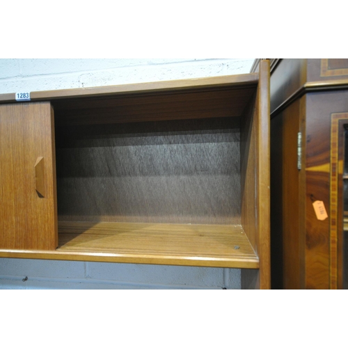 1283 - A MID CENTURY TEAK OPEN BOOKCASE, the top with two sliding doors, two shelves, above another two sli... 