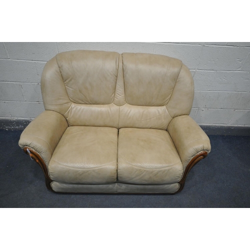 1410 - A ROSIN CREAM LEATHERETTE UPHOLSTERED TWO SEATER SOFA, length 144cm (condition - some discolouration... 