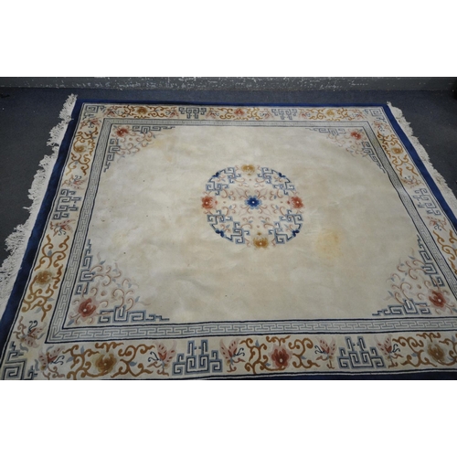 1413 - A LARGE RECTANGULAR CREAM GROUND CHINESE WOOLEN RUG, with foliate and geometric border and centre, l... 