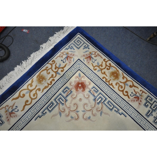 1413 - A LARGE RECTANGULAR CREAM GROUND CHINESE WOOLEN RUG, with foliate and geometric border and centre, l... 