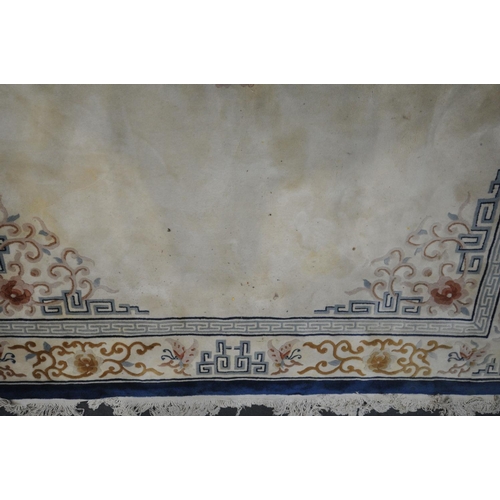 1413 - A LARGE RECTANGULAR CREAM GROUND CHINESE WOOLEN RUG, with foliate and geometric border and centre, l... 