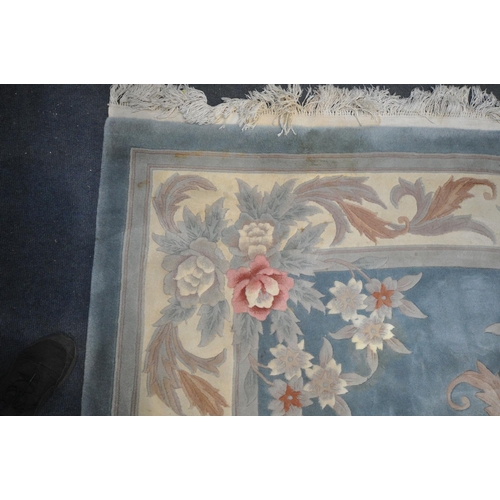 1414 - A LARGE RECTANGULAR BLUE GROUND CHINESEWOOLEN RUG, with multistrap border, and foliate decorations, ... 