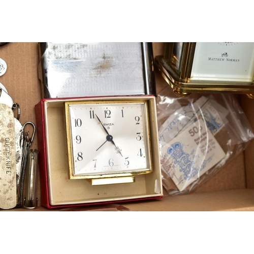 121 - A BOX OF MISCELLANEOUS ITEMS, to include a 'Matthew Norman' carriage clock, key wound with papers, a... 