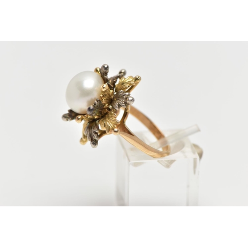 14 - A WHITE AND YELLOW METAL CULTURED PEARL RING, of foliate design, set with a principal part drilled w... 