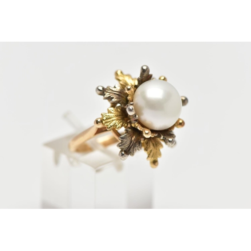 14 - A WHITE AND YELLOW METAL CULTURED PEARL RING, of foliate design, set with a principal part drilled w... 