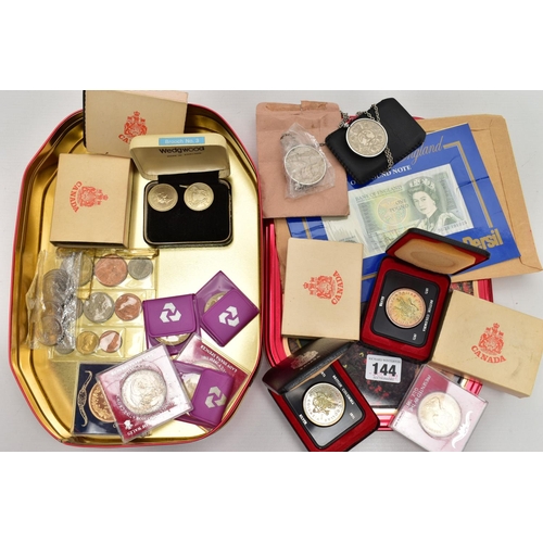 144 - A TIN OF ASSORTED COINS AND COMEMMORATIVES, to include four boxed 'Canada' coins, two commemorative ... 