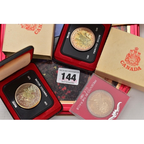 144 - A TIN OF ASSORTED COINS AND COMEMMORATIVES, to include four boxed 'Canada' coins, two commemorative ... 