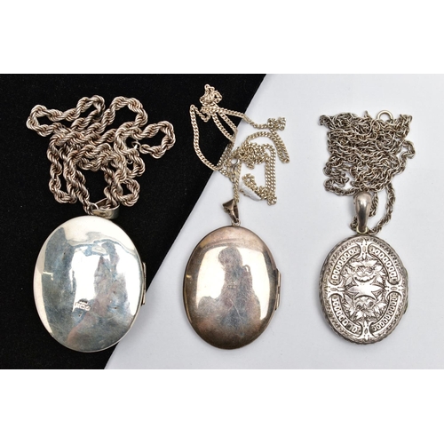 28 - A SELECTION OF SILVER AND WHITE METAL LOCKETS, WITH CHAINS, the first a silver embossed oval locket,... 