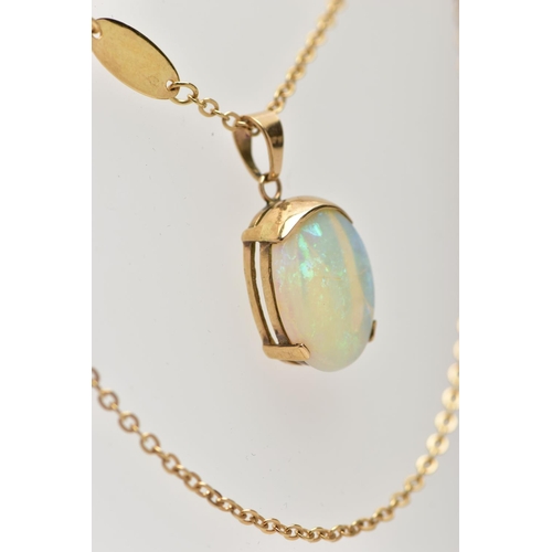 32 - A YELLOW METAL OPAL PENDANT WITH CHAIN, the oval opal cabochon, with yellow metal cap, tapered surmo... 