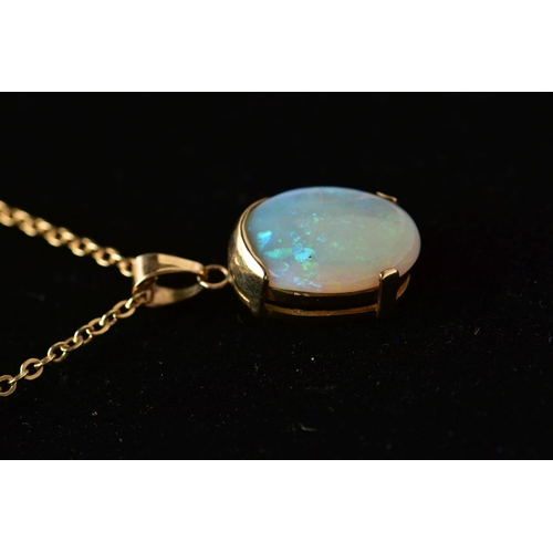 32 - A YELLOW METAL OPAL PENDANT WITH CHAIN, the oval opal cabochon, with yellow metal cap, tapered surmo... 