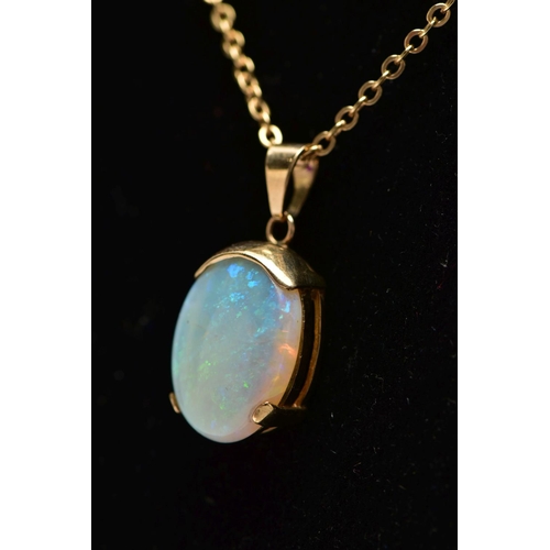 32 - A YELLOW METAL OPAL PENDANT WITH CHAIN, the oval opal cabochon, with yellow metal cap, tapered surmo... 