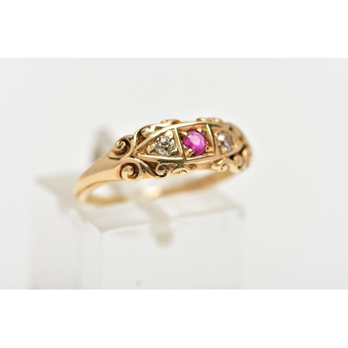 39 - AN EARLY 20TH CENTURY 18CT GOLD RUBY AND DIAMOND RING, set with a central circular cut ruby, flanked... 