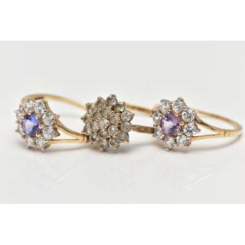 4 - THREE 9CT GOLD CLUSTER RINGS, the first a colourless cubic zirconia cluster ring, pinched shoulders ... 