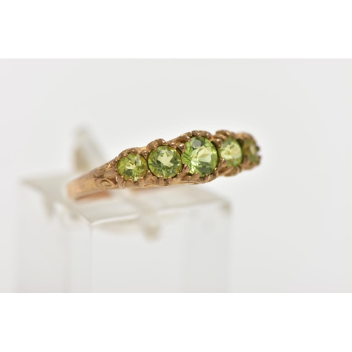 40 - A 9CT GOLD FIVE STONE PERIDOT RING, designed with five graduated circular cut peridots, scrolling ga... 