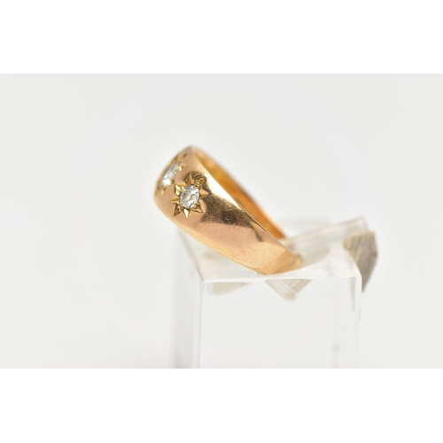 52 - AN 18CT GOLD DIAMOND THREE STONE RING, the graduated old cut diamonds, within a star setting, to the... 