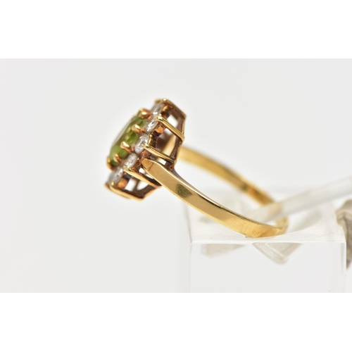 53 - AN 18CT GOLD PERIDOT AND DIAMOND CLUSTER RING, the oval cut peridot, with brilliant cut diamond surr... 