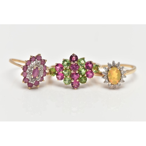 6 - THREE GEM SET RINGS, the first designed as a tiered lozenge shape cluster centring on a marquise cut... 