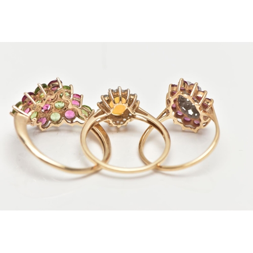 6 - THREE GEM SET RINGS, the first designed as a tiered lozenge shape cluster centring on a marquise cut... 