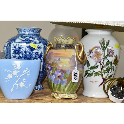 302 - A GROUP OF CERAMIC ORNAMENTS, VASES AND LAMPS comprising a hand painted Japanese Noritake twin handl... 