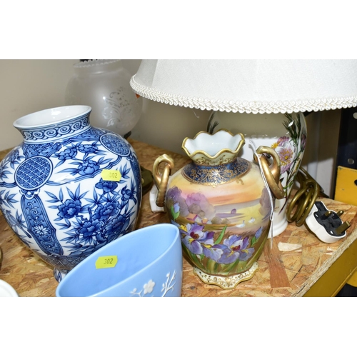 302 - A GROUP OF CERAMIC ORNAMENTS, VASES AND LAMPS comprising a hand painted Japanese Noritake twin handl... 