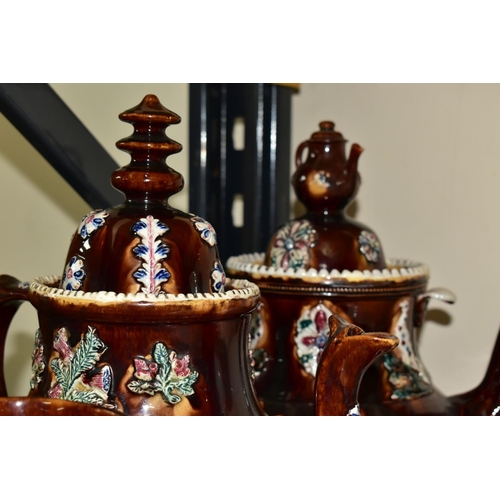 323 - SEVEN PIECES OF MEASHAM BARGEWARE, comprising two large teapots, one having a teapot shaped finial a... 