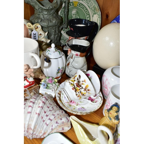 332 - A GROUP OF CERAMIC ORNAMENTS comprising an ostrich egg on a square wooden stand, a Royal Doulton 191... 