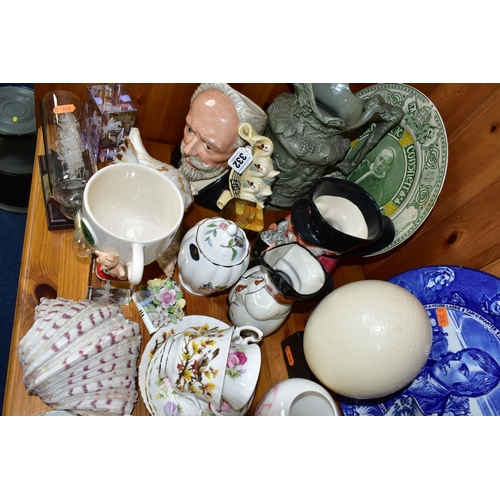 332 - A GROUP OF CERAMIC ORNAMENTS comprising an ostrich egg on a square wooden stand, a Royal Doulton 191... 