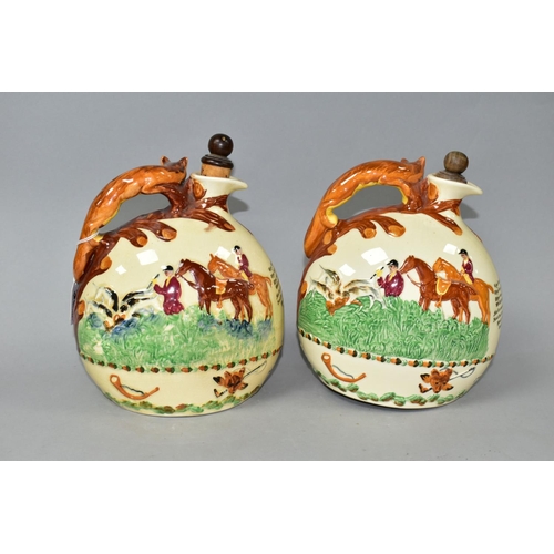 369 - TWO CROWN DEVON JOHN PEEL MUSICAL FLASKS, with wooden stoppers, relief moulded scenes and handles in... 