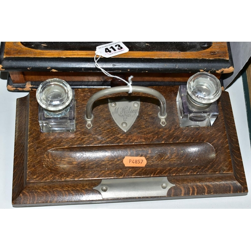 413 - THREE EARLY TO MID 20TH CENTURY WOODEN STATIONERY ITEMS, comprising a desk tidy with two glass ink w... 