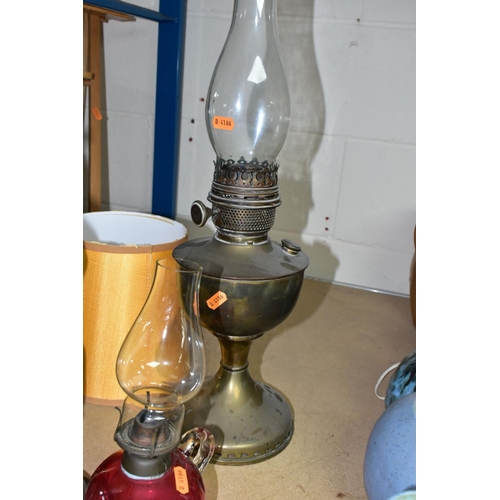 508 - A GROUP OF FOUR LAMPS, comprising a brass oil lamp, height 56cm to top of glass chimney (no shade), ... 