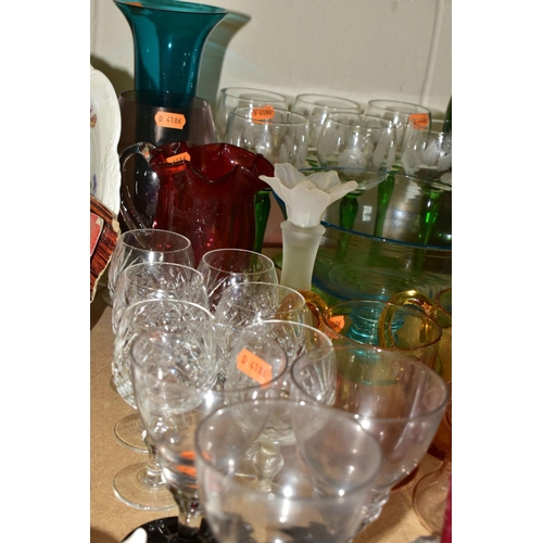 525 - A GROUP OF COLOURED GLASSWARE comprising a set of six German style green stemmed wine glasses with a... 