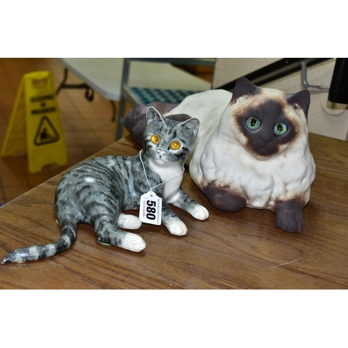 580 - TWO MIKE HINTON CATS comprising a porcelain grey tabby cat with yellow glass eyes, signed on base No... 