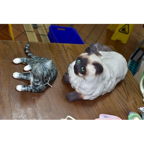 580 - TWO MIKE HINTON CATS comprising a porcelain grey tabby cat with yellow glass eyes, signed on base No... 