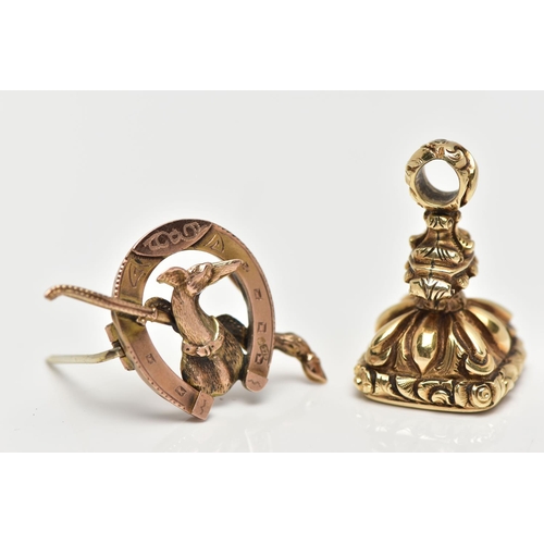 11 - A 9CT GOLD BROOCH AND A YELLOW METAL FOB SEAL, the brooch designed as a horseshoe with whippet and r... 