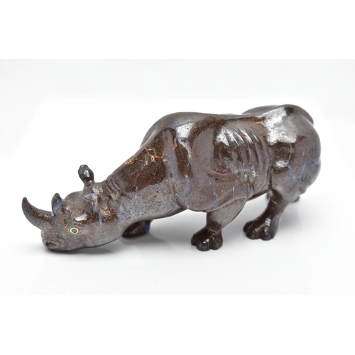 22 - A CARVED BOULDER OPAL RHINO, the figure designed as a rhino, carved from boulder opal, with green ga... 